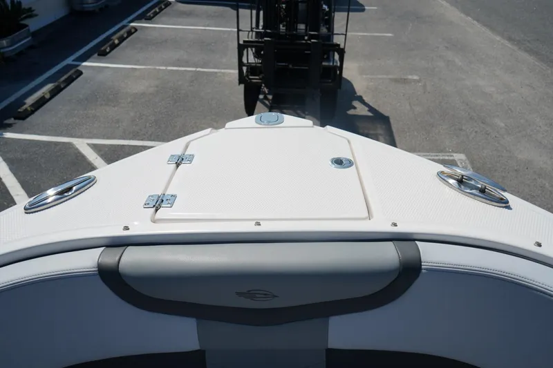 Slide: The Image of 2025 Chaparral 270 OSX boat bow view in a parking lot. - 12