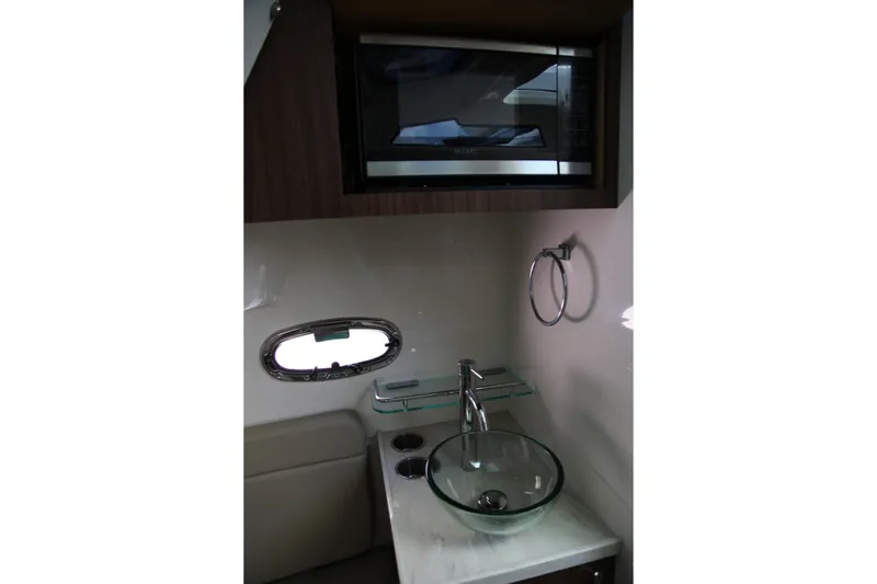 Slide: The Image of 2019 Boston Whaler 380 Outrage interior with modern sink and microwave. - 49