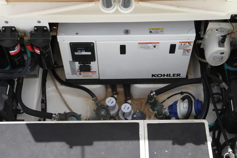 Slide: The Image of Engine compartment of a 2019 Boston Whaler 380 Outrage featuring a Kohler generator. - 31