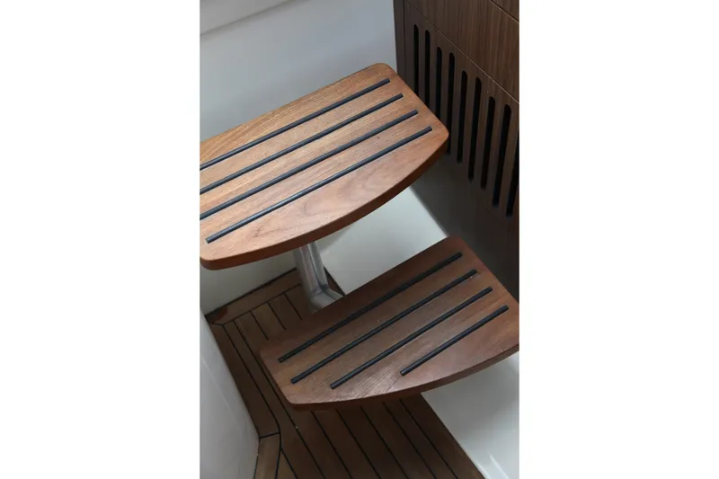 Slide: The Image of Wooden steps on a 2019 Boston Whaler 380 Outrage boat interior. - 46