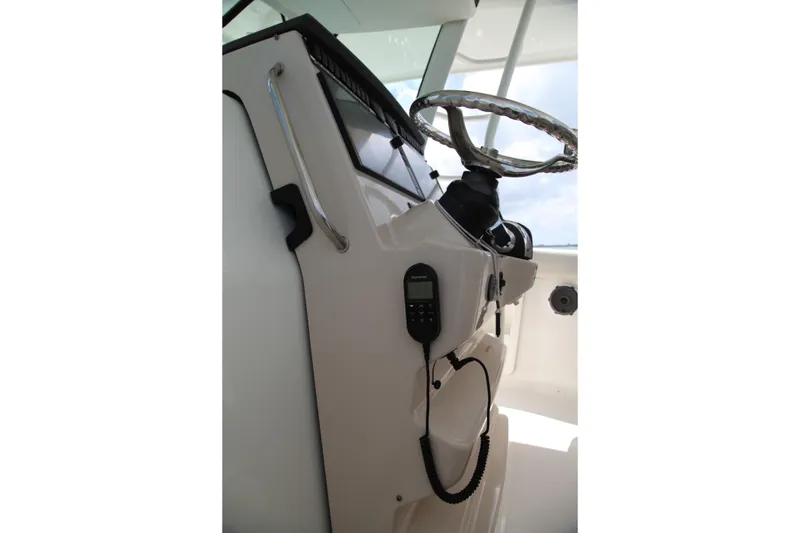 Slide: The Image of 2019 Boston Whaler 380 Outrage helm with steering wheel and control panel. - 24