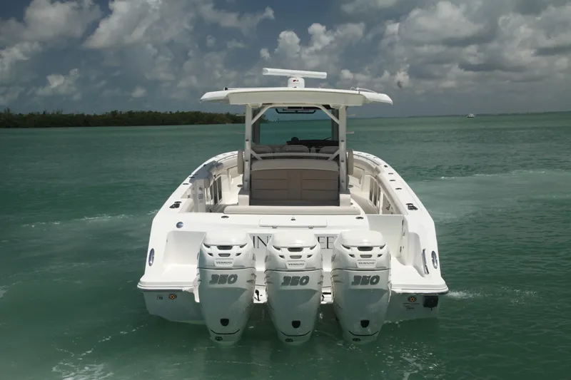 Slide: The Image of 2019 Boston Whaler 380 Outrage with triple engines on open water. - 2