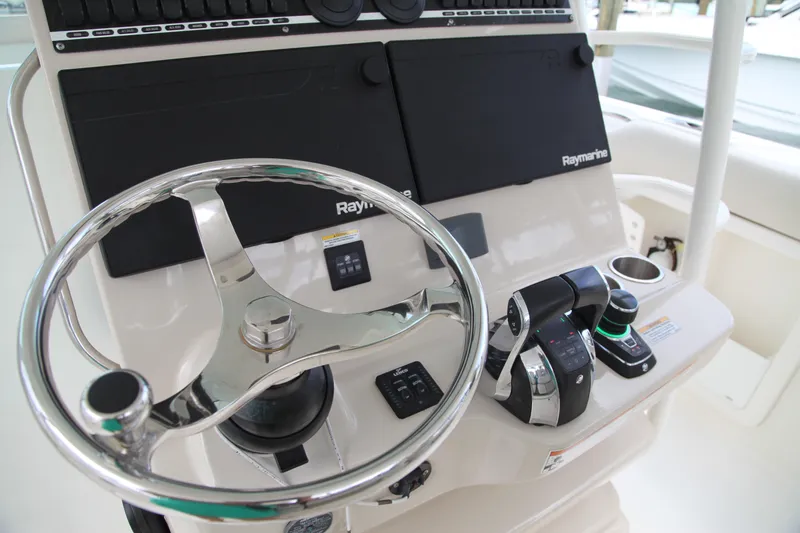 Slide: The Image of Control panel of a 2019 Boston Whaler 380 Outrage with steering wheel and navigation equipment. - 6