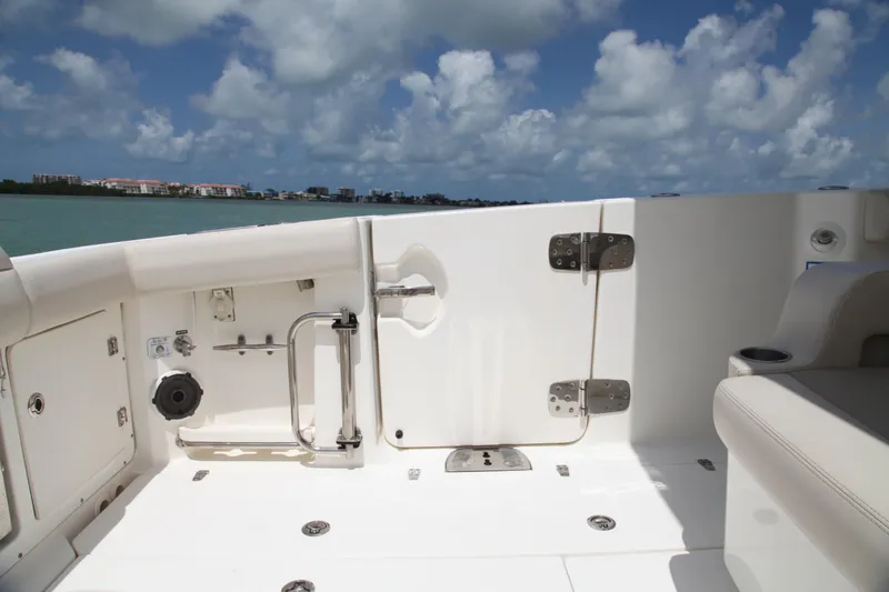 Slide: The Image of 2019 Boston Whaler 380 Outrage boat deck with seating, ocean view, and blue sky. - 22