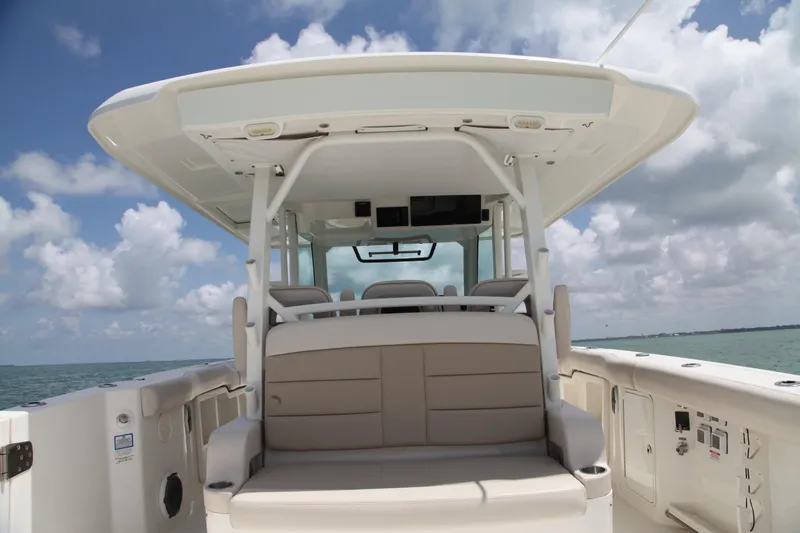 Slide: The Image of 2019 Boston Whaler 380 Outrage boat interior with seating, under a cloudy sky. - 29