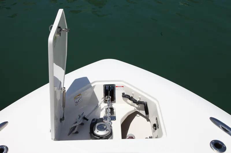 Slide: The Image of 2019 Boston Whaler 380 Outrage anchor compartment with open hatch, on calm water. - 61