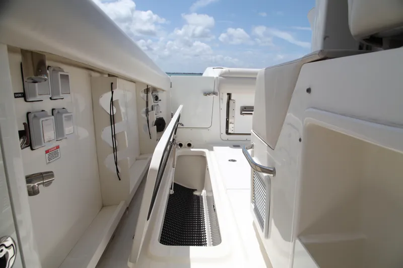 Slide: The Image of 2019 Boston Whaler 380 Outrage deck with storage compartments and utility features. - 38