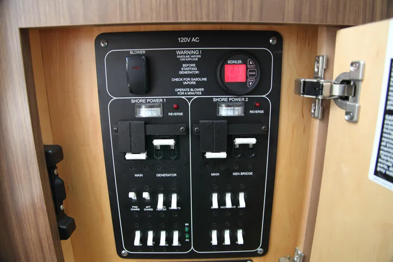 Slide: The Image of Electrical panel of a 2019 Boston Whaler 380 Outrage boat, featuring shore power controls. - 36