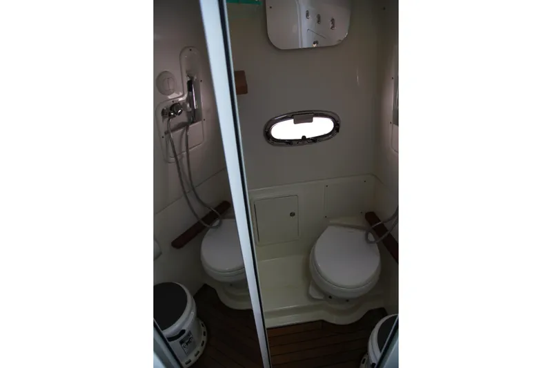 Slide: The Image of Interior of 2019 Boston Whaler 380 Outrage boat bathroom with shower and toilet. - 45