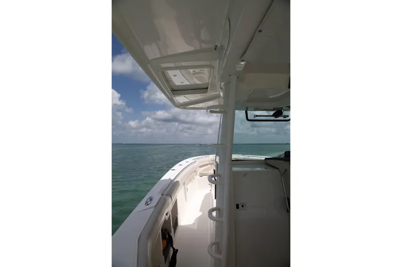Slide: The Image of 2019 Boston Whaler 380 Outrage boat on open water under a cloudy sky. - 25