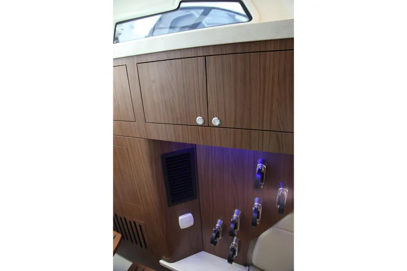 Slide: The Image of Interior of 2019 Boston Whaler 380 Outrage with wooden cabinetry and modern controls. - 52
