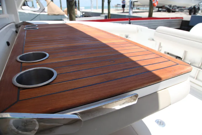 Slide: The Image of Teak deck with cup holders on 2019 Boston Whaler 380 Outrage boat. - 55