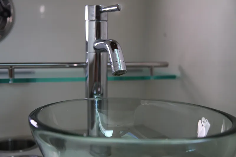 Slide: The Image of Modern glass sink and chrome faucet on 2019 Boston Whaler 380 Outrage boat. - 48