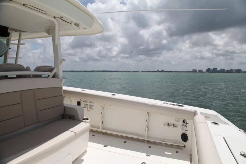 Slide: The Image of 2019 Boston Whaler 380 Outrage boat interior with ocean view under cloudy sky. - 28