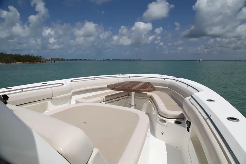 Slide: The Image of 2019 Boston Whaler 380 Outrage boat interior with seating and table, ocean view. - 17