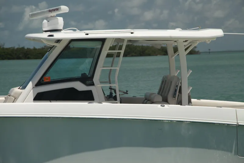 Slide: The Image of 2019 Boston Whaler 380 Outrage boat on calm water, featuring sleek design and modern equipment. - 43
