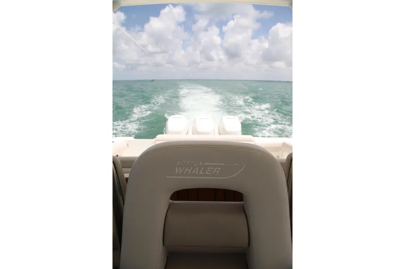 Slide: The Image of 2019 Boston Whaler 380 Outrage cruising on open water under a cloudy sky. - 41