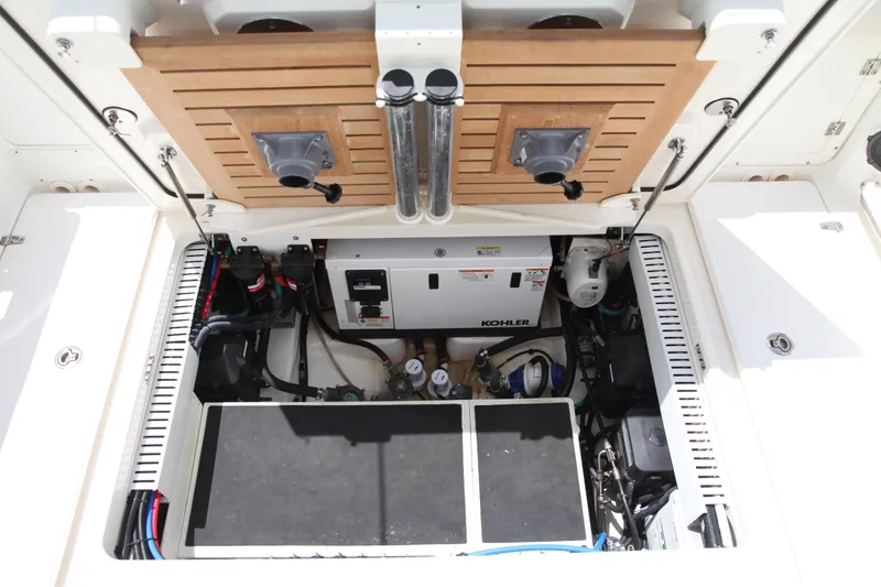 Slide: The Image of Engine compartment of a 2019 Boston Whaler 380 Outrage, featuring Kohler generator and equipment. - 30
