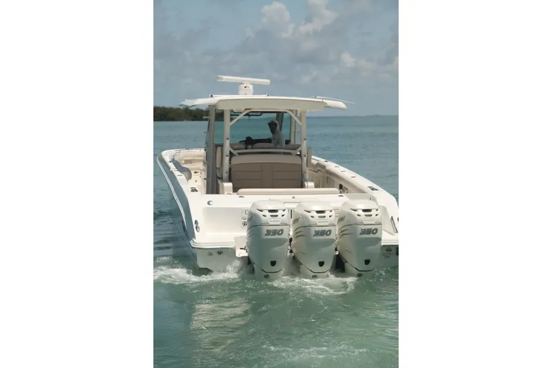 Slide: The Image of 2019 Boston Whaler 380 Outrage boat with triple engines on calm water. - 3