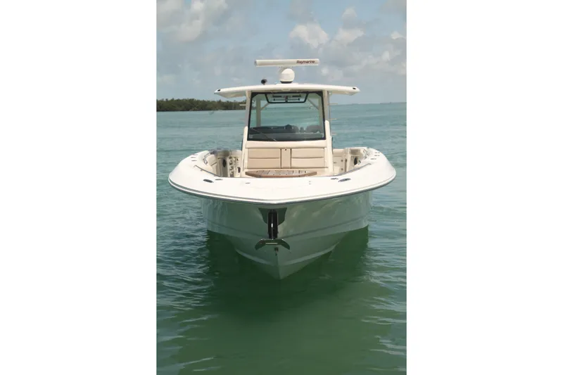 Slide: The Image of 2019 Boston Whaler 380 Outrage boat on calm water, front view. - 5