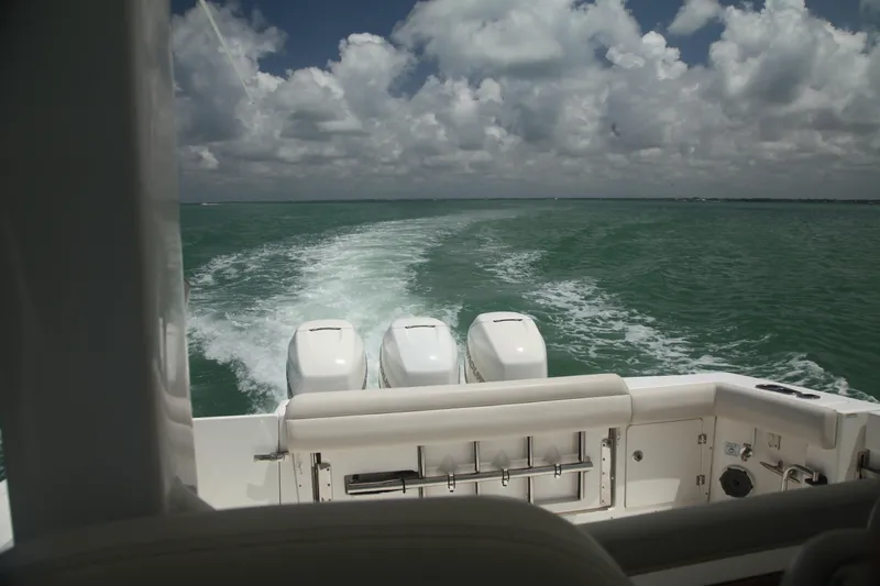 Slide: The Image of 2019 Boston Whaler 380 Outrage cruising on open water under cloudy skies. - 42