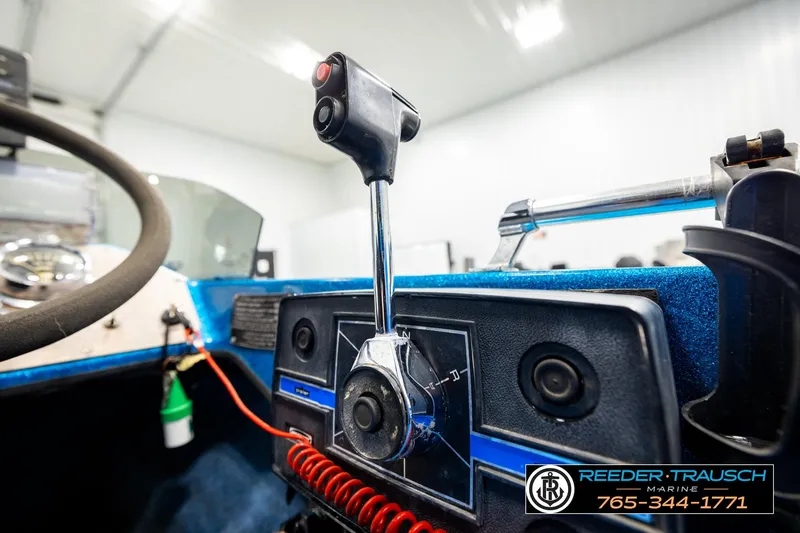 Slide: The Image of 1980 Ranger 175 VS boat dashboard with steering wheel and control lever. - 33