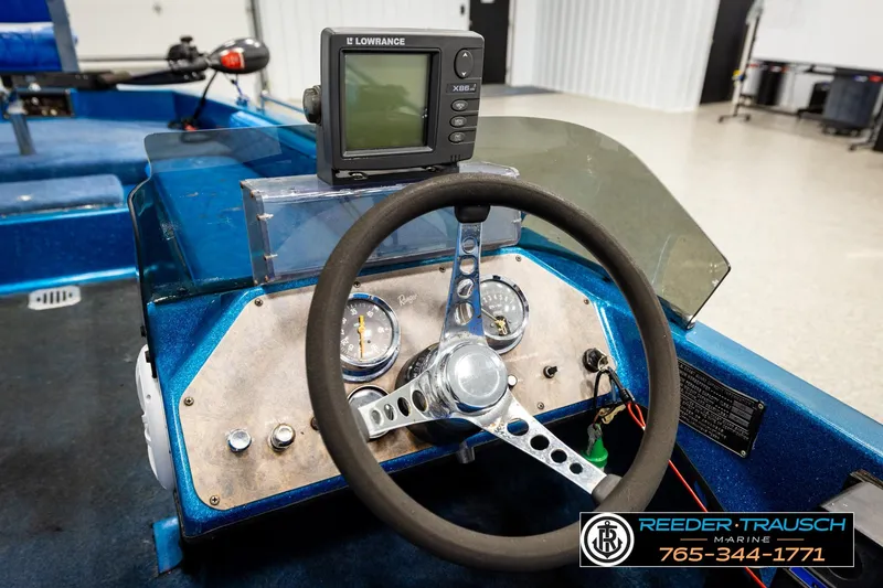 Slide: The Image of 1980 Ranger 175 VS boat dashboard with steering wheel and Lowrance fish finder. - 23
