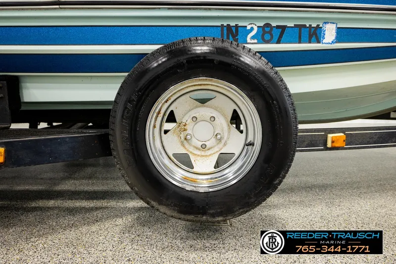 Slide: The Image of 1980 Ranger 175 VS boat trailer tire with visible license number and dealership logo. - 41