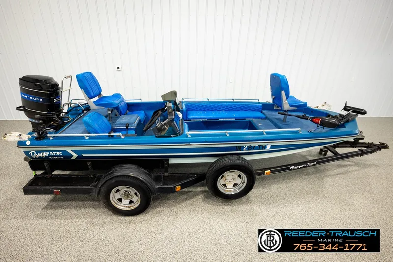 The Image of 1980 Ranger 175 VS boat with blue seats and Mercury outboard motor on trailer. - 1