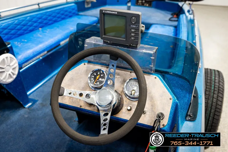 Slide: The Image of 1980 Ranger 175 VS boat dashboard with steering wheel and Lowrance fish finder. - 22