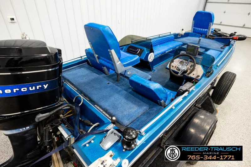 Slide: The Image of 1980 Ranger 175 VS boat with blue interior and Mercury engine in showroom. - 10