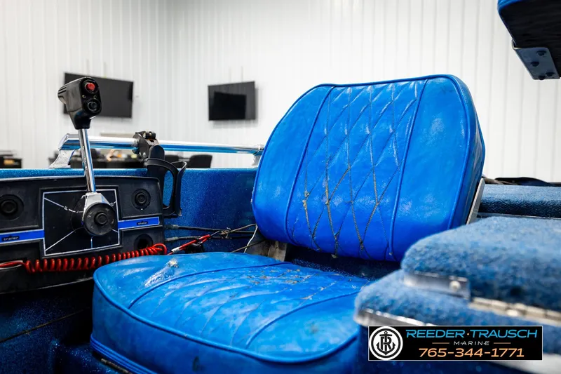 Slide: The Image of 1980 Ranger 175 VS boat interior with blue seating and control panel. - 29