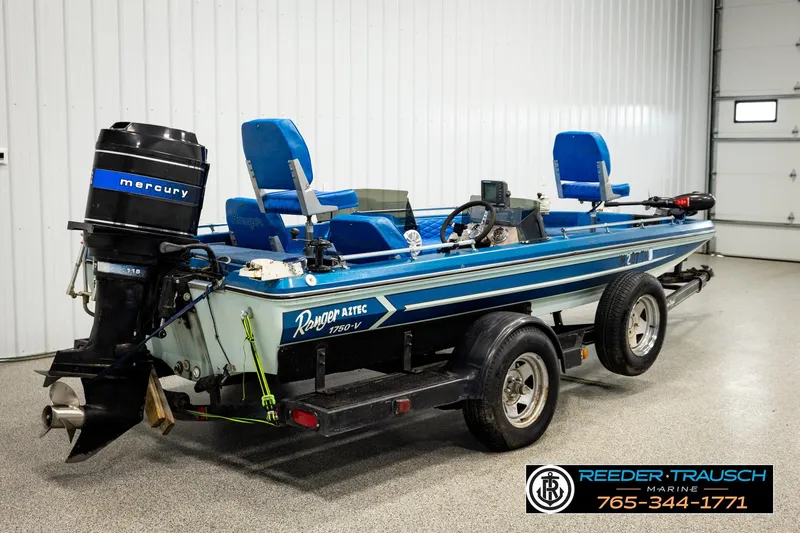 Slide: The Image of 1980 Ranger 175 VS boat with Mercury outboard motor on trailer in garage setting. - 4