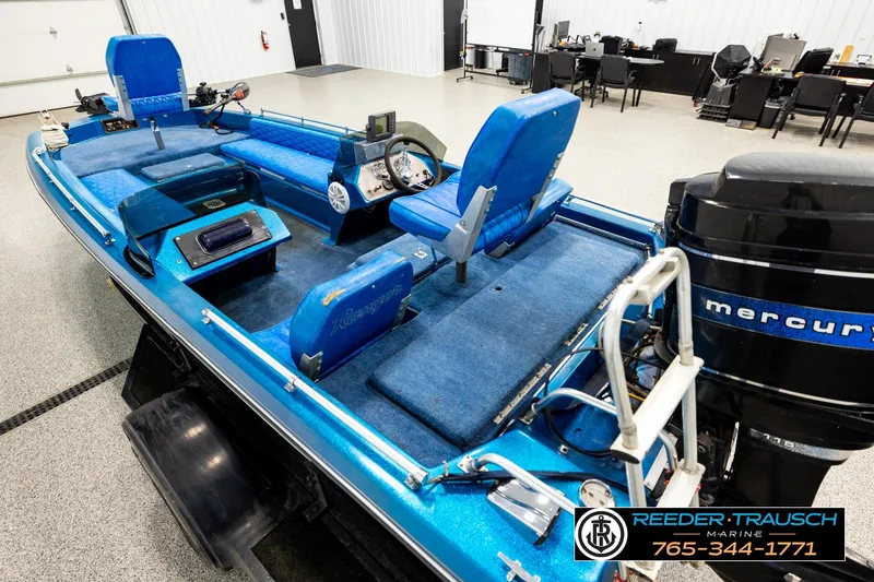 Slide: The Image of 1980 Ranger 175 VS boat with blue interior and Mercury outboard motor in showroom. - 9
