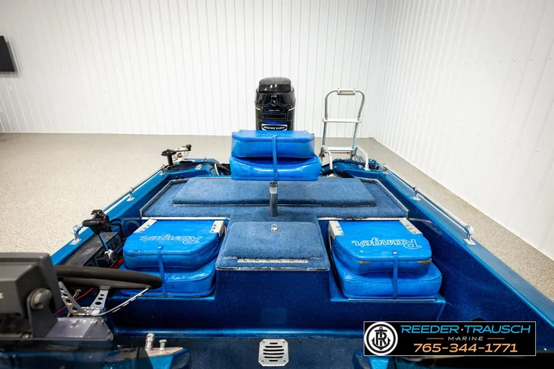 Slide: The Image of 1980 Ranger 175 VS boat interior with blue seating and Mercury outboard motor. - 17