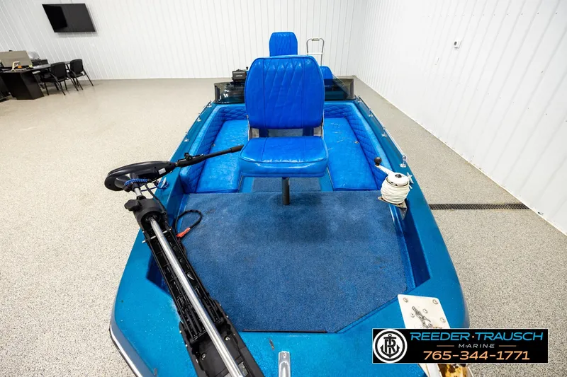 Slide: The Image of 1980 Ranger 175 VS boat with blue seating and trolling motor in showroom. - 14