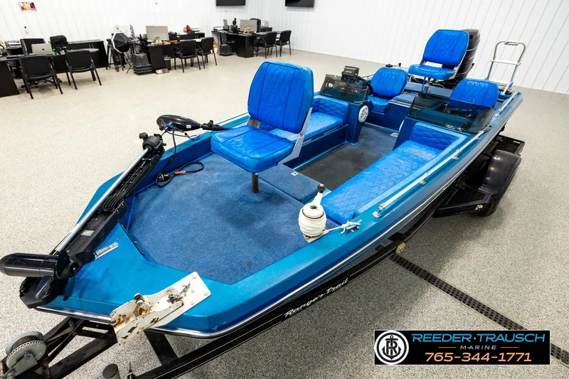 Slide: The Image of 1980 Ranger 175 VS boat with blue seating, displayed indoors at Reeder Trausch Marine. - 8