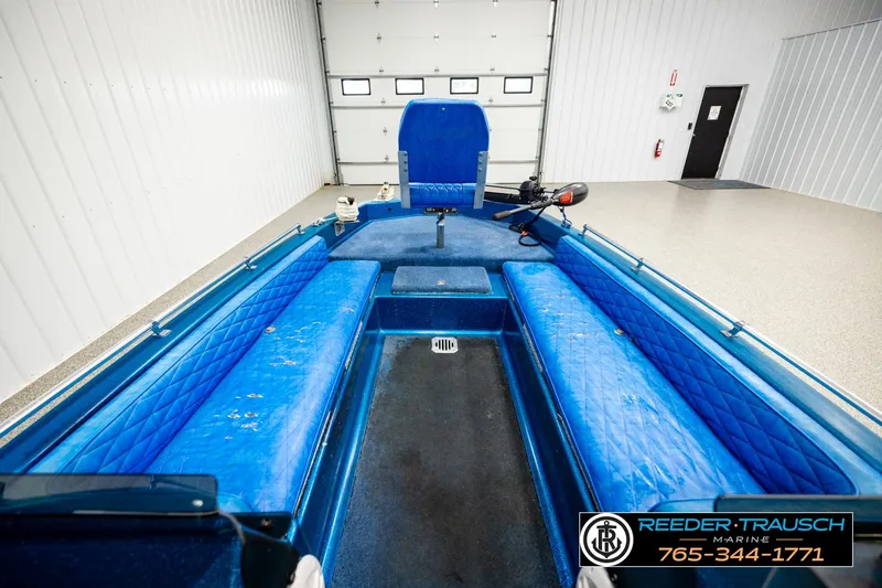 Slide: The Image of 1980 Ranger 175 VS boat interior with blue seating in a garage setting. - 20