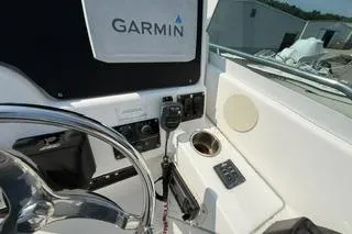 Slide: The Image of 2003 Edgewater 265 Express boat dashboard with Garmin navigation system and controls. - 21