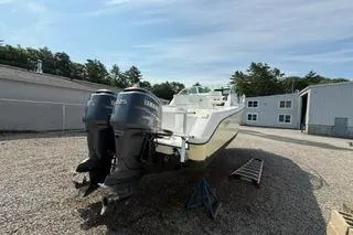 Slide: The Image of 2003 Edgewater 265 Express boat with dual Yamaha outboard motors on gravel lot. - 35