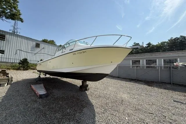 Slide: The Image of 2003 Edgewater 265 Express boat on gravel lot, side view. - 5