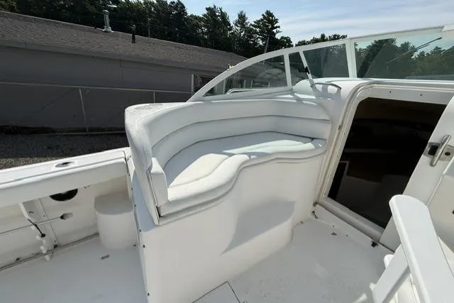 Slide: The Image of 2003 Edgewater 265 Express boat with white seating and open cabin entrance. - 8