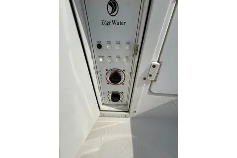Slide: The Image of Control panel of a 2003 Edgewater 265 Express boat, featuring dials and switches. - 32