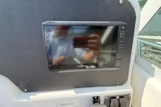 Slide: The Image of 2003 Edgewater 265 Express boat dashboard with electronic display and controls. - 22
