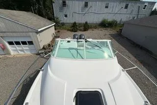Slide: The Image of 2003 Edgewater 265 Express boat parked near garages, viewed from above. - 26