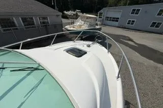 Slide: The Image of 2003 Edgewater 265 Express boat docked near buildings. - 24