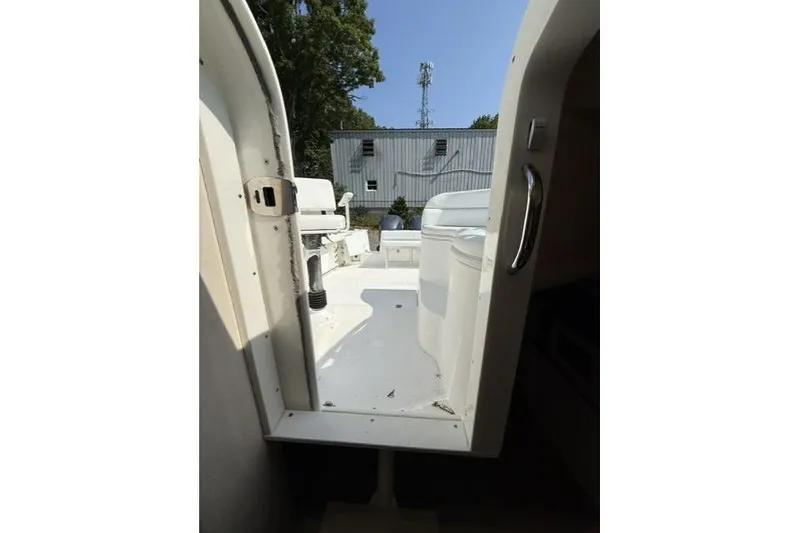 Slide: The Image of Interior view of 2003 Edgewater 265 Express boat, showing open cabin door and deck. - 16