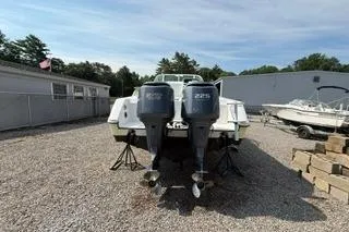 Slide: The Image of 2003 Edgewater 265 Express boat with dual outboard motors on gravel lot. - 36