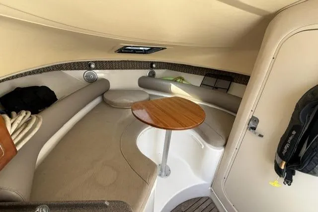 Slide: The Image of Interior cabin of 2003 Edgewater 265 Express boat with seating and table. - 14