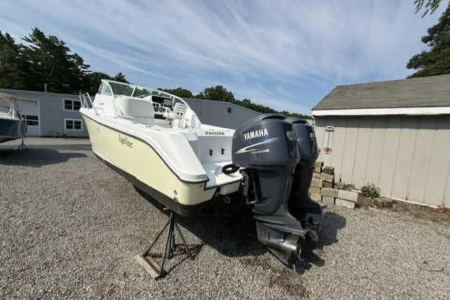 Slide: The Image of 2003 Edgewater 265 Express boat with Yamaha engines on gravel lot. - 3